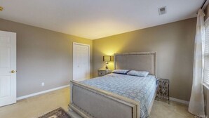 A bedroom with a bed, nightstands, a door, and a window with curtains. - Private bedroom and bath!  (Midlothian)