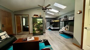 A compact living space with a sofa, coffee table, and bunk beds. - Secluded Hillside Cabin on Historic working Farm (Lampe)
