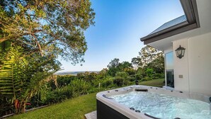 Un bain à remous dans un jardin, avec vue sur le paysage.