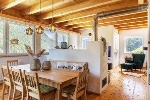 A wooden dining table with chairs, a bench, and a refrigerator. - Holiday Home 'Maierhof 341' with Lake View, Private Terrace and Wi-Fi (See)