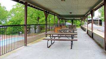 Enjoy outdoor dining and relaxation in this serene picnic area with picnic tables and benches.