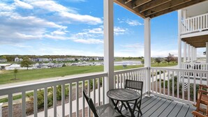 A covered porch with a view of a marina and residential buildings. - Mansion Flat @ Navvy Town (Ottawa)