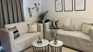 A modern living room with two sofas, a coffee table, and wall art. - Across the Street from the Ocean Life Bucerias 129 (Bucerías)