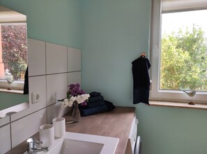 Shower, hair dryer, slippers, towels