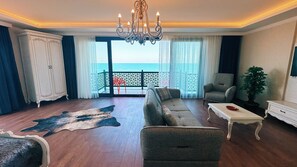 Family Room, Non Smoking, Sea View | Living area | 82-cm plasma TV with satellite channels, DVD player, heated floors - BİLİRİS HOTEL (Akçaabat)