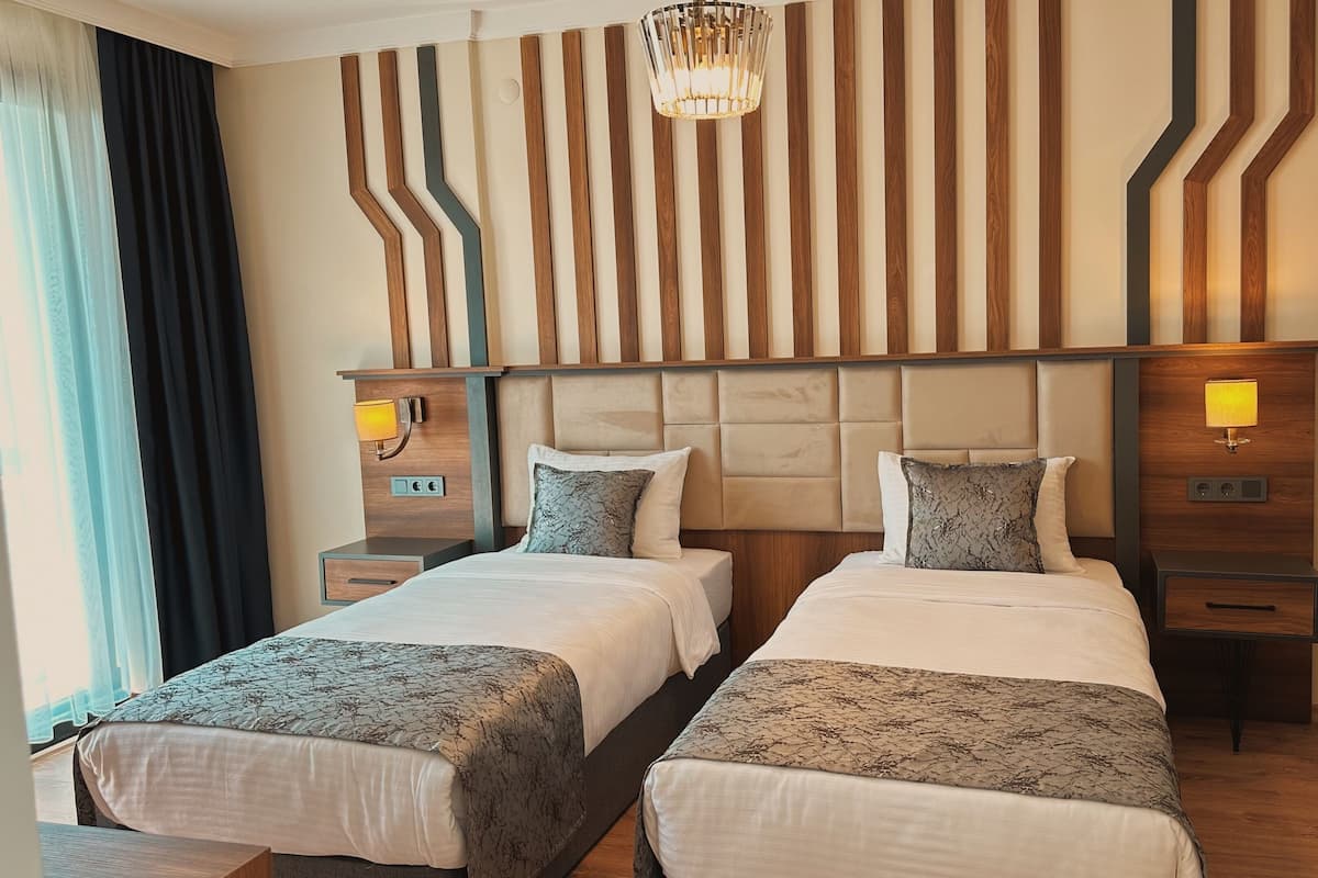 Deluxe Quadruple Room, Non Smoking, Sea View | Frette Italian sheets, premium bedding, down comforters, minibar