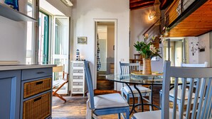 A kitchen with a dining table, chairs, and a wicker basket.