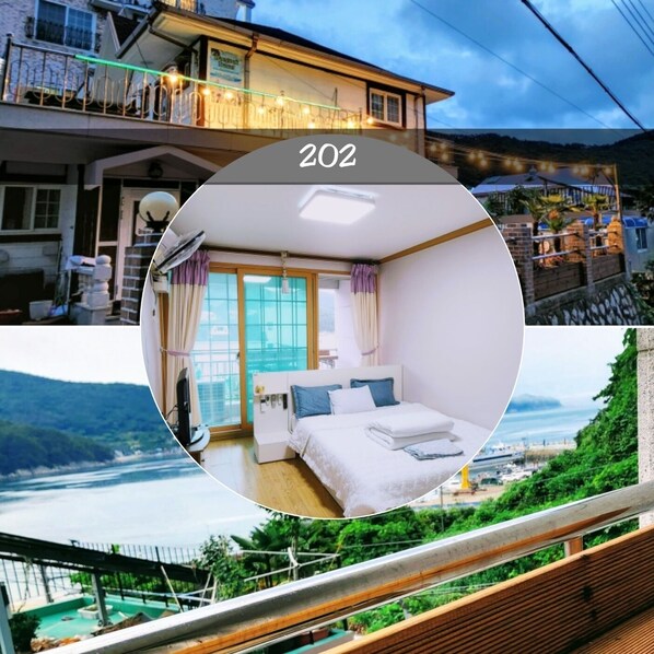 A hotel room with a bed, a TV, and a view of the sea. - Relax and Enjoy the Beauty of Bird Song and Crashing Waves (Geoje-si)