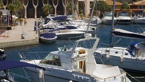 A marina with several boats docked, a pedestrian walkway, and buildings in the background. - Beachside Studio with Terrace, A/C, Parking - Sleeps 4 in Fréjus (Fréjus)