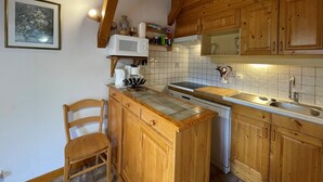A kitchen with wooden cabinets, a microwave, a coffee maker, and a sink. - Ski-in/Ski-out, Sleeps 6, 3 Rooms, Balcony, Parking, Crest-Voland (Crest-Voland)