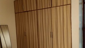 A bedroom with a large wardrobe, a bed, and a mirror. - Affordable Heaven by CHH (Nairobi)