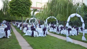 An outdoor wedding venue with rows of tables and chairs, decorated with white tablecloths and purple sashes. - ABDULLAH RESORT OTEL (Polatli)
