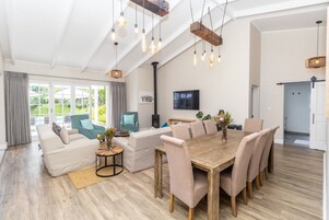 Family House | Living area | 55-inch flat-screen TV with satellite channels, books