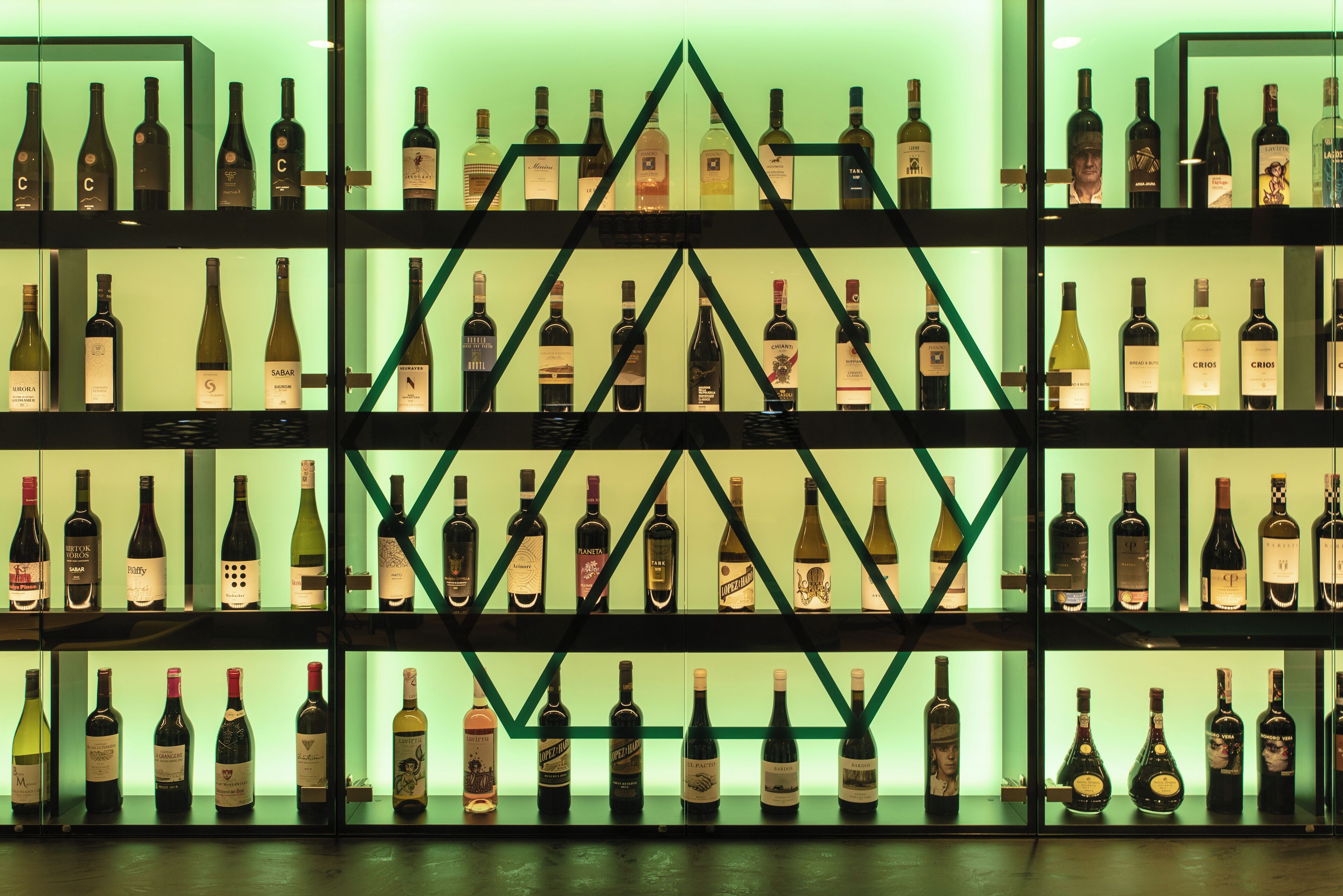 A wine rack with multiple shelves and bottles.