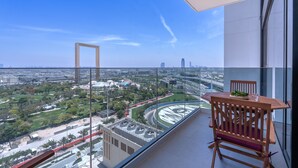 A balcony with a view of a cityscape, including a roundabout and buildings. - Vogue| Al Wasl 1 Residence near World Trade Centre (Dubai)