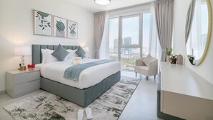A modern bedroom with a bed, bedside tables, a chair, a large window, and artwork on the wall. - Vogue| Al Wasl 1 Residence near World Trade Centre (Dubai)