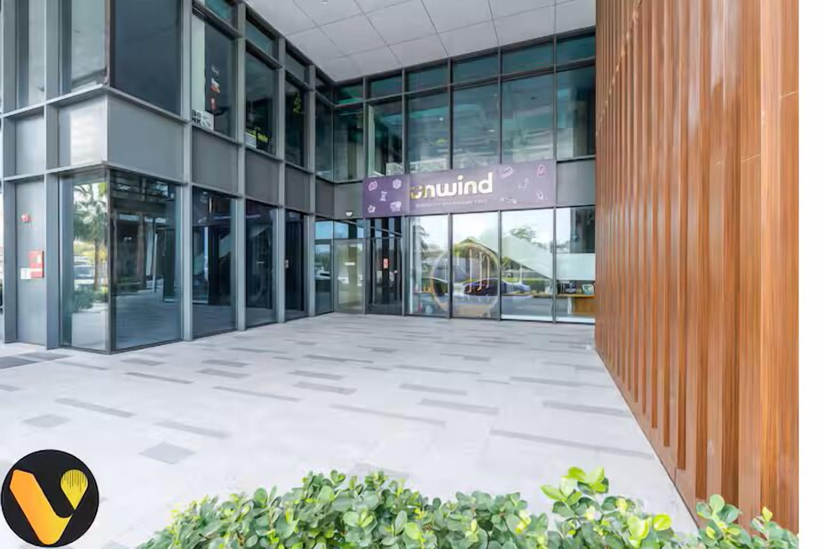 A modern building with a glass facade, a sign reading "Onwind," and a logo in the bottom left corner.