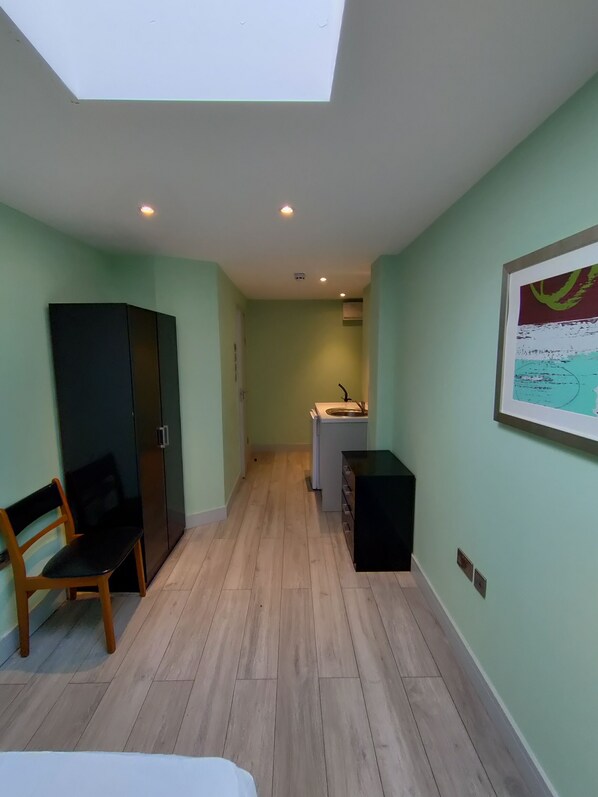 A compact room with a skylight, a kitchenette, a wardrobe, and a seating area. - Letzi private en-suite, Near Heathrow Airport T3 (Hayes)