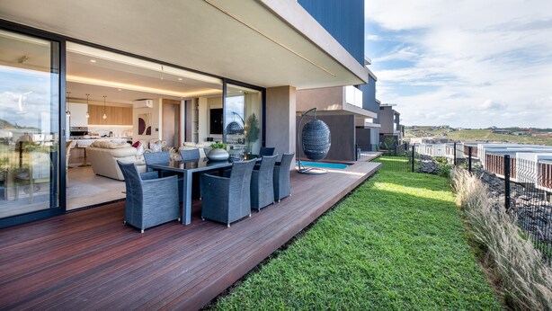 A modern house with a deck, outdoor furniture, and a view of the landscape. - 1 Savili - Zululami (Ballito)