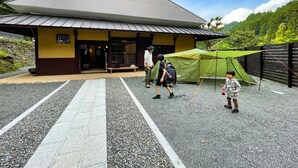 A traditional building with a sloped roof and a signboard. - Tagomori no Akari (Ukiha)