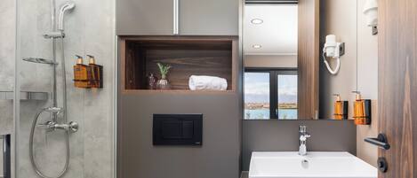 A modern bathroom with a shower, a sink, and a mirror.