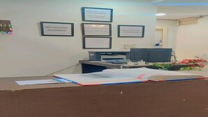 A reception desk with framed notices, a printer, and a computer. - Hotel The Green Arrow (New Delhi)