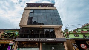 A building with a sign reading "DIVINE GUEST HOUSE" at the entrance. - MeroStay 127 Divine Guest House (Kathmandu)