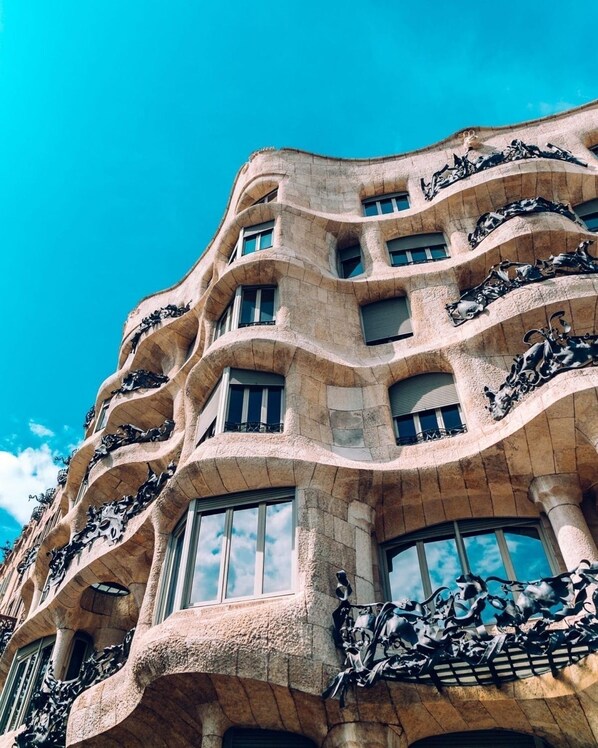 A building with a unique architectural style featuring curved balconies and large windows.