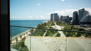 A cityscape with a view of the ocean, high-rise buildings, and a park area. - Batumi View Luxury  (Batumi)