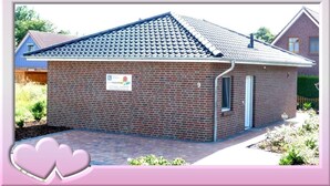 A small brick building with a tiled roof, a sign indicating it is a residential property, and a number '9' on the side. - 2 bedroom private vacation home in wurster nordseekã¼ste (Wurster Nordseeküste)