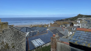 A coastal town with stone buildings, a beach, and a hill with a fort. - Silver Seahorse - a cottage that sleeps 6 guests in 3 bedrooms (St Ives)