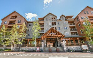 A multi-story hotel with a prominent entrance, stone steps, and a sign reading "Buffalo Lodge."
