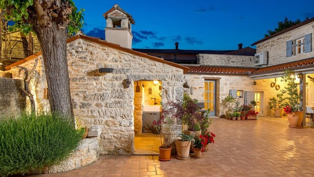 A stone building with a small tower, a covered outdoor area with potted plants, and a brick patio. - Rustic Villa Folirantica with pool (Foli)