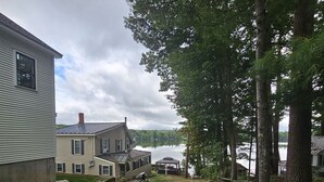 A residential property with a large lawn, a gazebo, and a lake view.