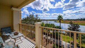A balcony with a view of a river and trees. - Vista Cay Lakeview Elysium 3 Bedroom Condo by RedAwning (Orlando)