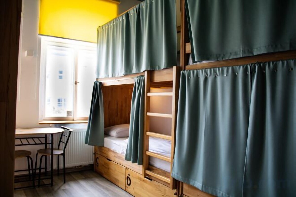 Premium bedding, desk, laptop workspace, blackout drapes