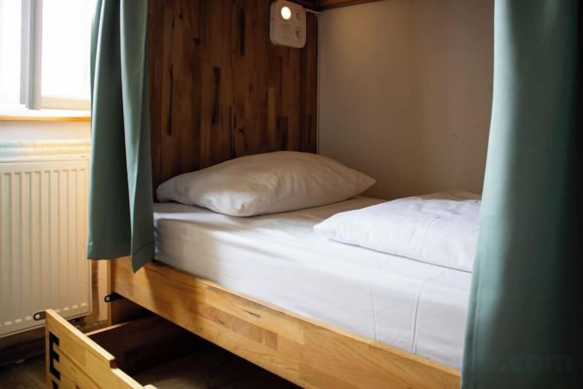 Premium bedding, desk, laptop workspace, blackout drapes