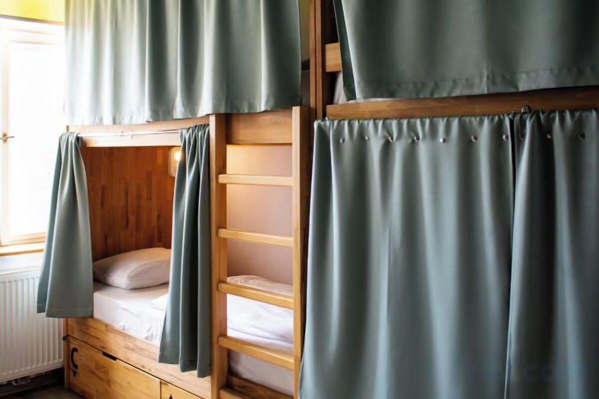 Premium bedding, desk, laptop workspace, blackout drapes