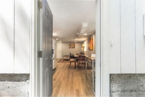Comfortable room with a dining area, door, and window.