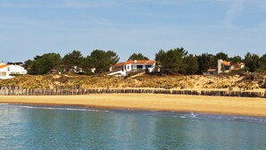 A coastal area with houses, a sandy beach, and a wooden fence. - Beach House with 180 degree sea views, 6 Bed, 4 Baths, sleeps 10-12 (La Tranche Sur Mer)