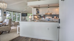 A modern kitchen with white cabinetry, a central island, and pendant lighting. - Private Home, Marsh Front Gorgeous View 874 Fiddlers Ridge (Fripp Island)