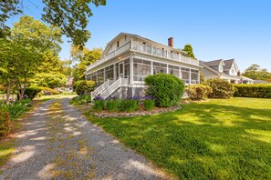 Traditional home with a charming porch and well-manicured lawn.