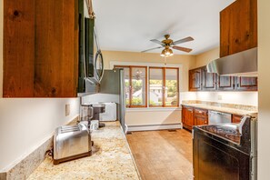 Enjoy cooking in this well-equipped kitchen with an oven, stovetop, and ample counter space.