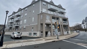 A multi-story building with a brick facade and multiple balconies.