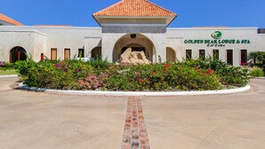 A building with a tiled roof, an arched entrance, and a sign reading "Golden Bear Lodge & Spa". - 2BDR Cap Cana Retreat @ GBL (Punta Cana)