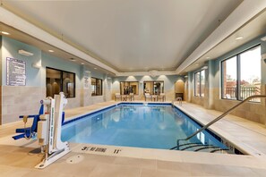 An indoor swimming pool with a lifeguard chair, pool rules sign, and a no diving sign. - Holiday Inn Express Holly Springs Raleigh Area by IHG (Holly Springs)
