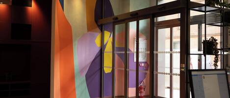 A reception area with a glass door, a computer monitor, and a fire extinguisher.
