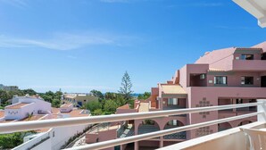 A pink building with balconies and a clear blue sky. - #132 Velamar 414 by Home Holidays (Albufeira)