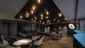 A modern interior with a herringbone wood floor, contemporary furniture, and a ceiling with multiple recessed lights. - Mercure Tokyo Haneda Airport (Tokyo)