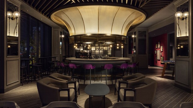 A modern bar area with a circular ceiling design, bar stools, and a seating arrangement with tables and chairs. - Mercure Tokyo Haneda Airport (Tokyo)